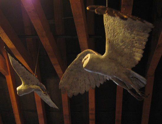 Pair of Barn Owl sculptures, bronze, hanging in a barn, Acton Court
